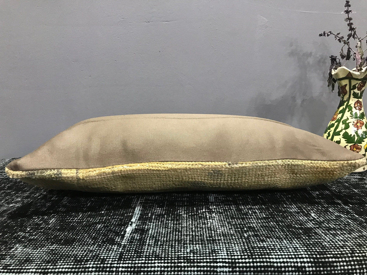 Beige Turkish throw pillow, shown on the floor.