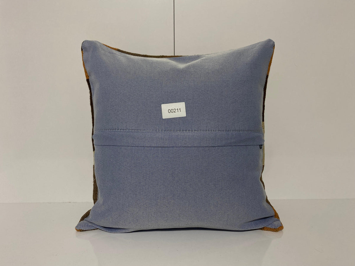 Close-up of the brown Turkish throw pillow showing geometric details, low pile.