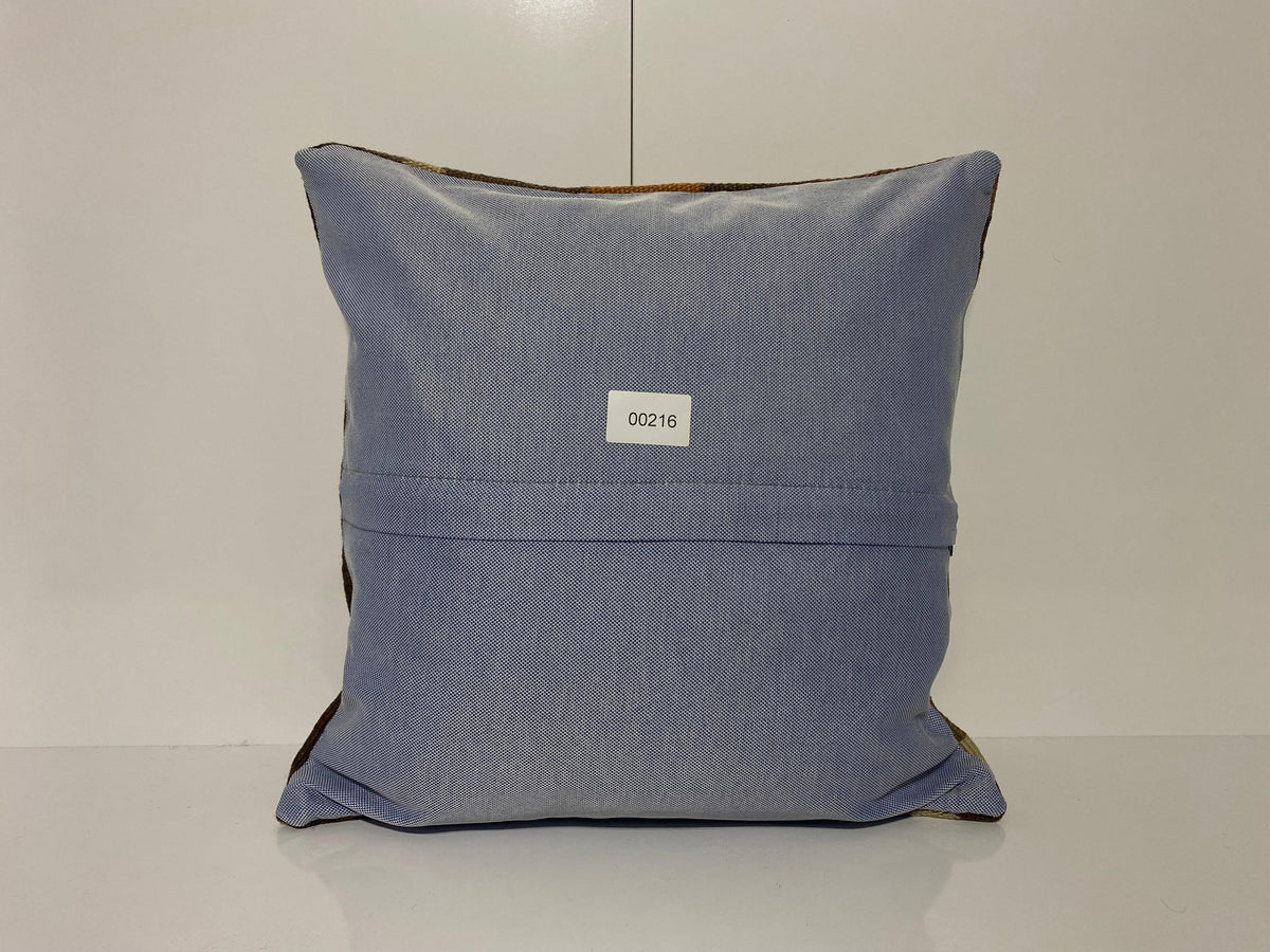Close-up of the brown Turkish throw pillow showing geometric details, low pile.