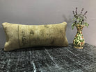 Brown Turkish throw pillow, shown on the floor.