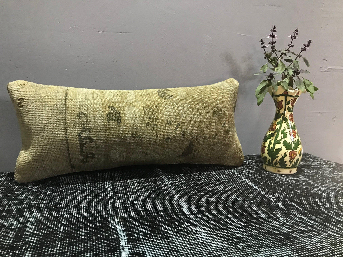 Brown Turkish throw pillow, shown on the floor.