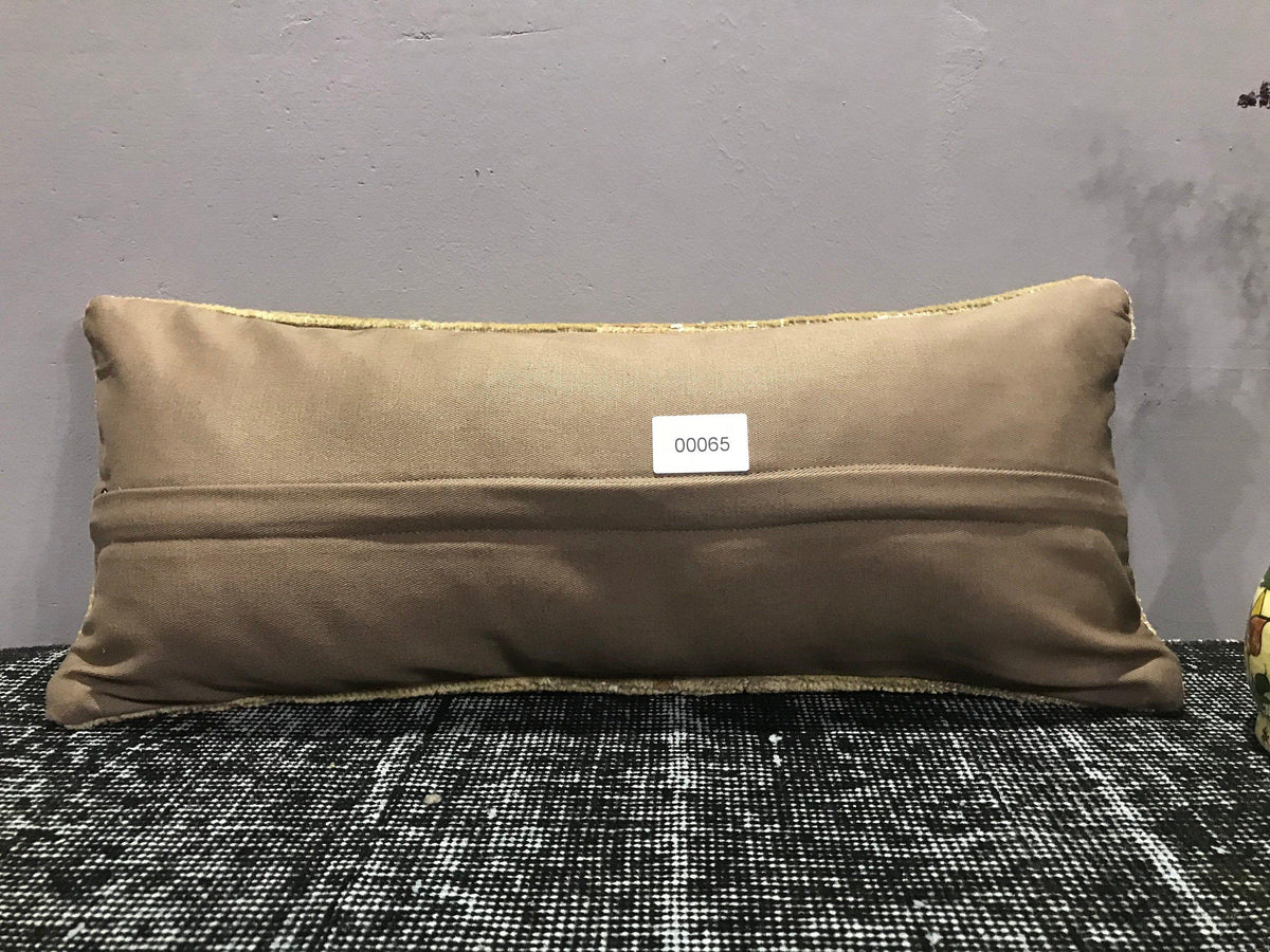Colorful Turkish throw pillow, shown on the floor.