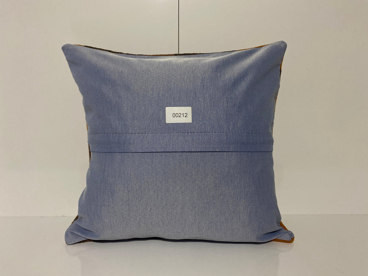 Close-up of the orange Turkish throw pillow showing geometric details, low pile.