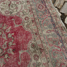 Close-up of the red Turkish traditional anatolian rug showing traditional details, hand-knotted weave, wool and cotton and low pile.