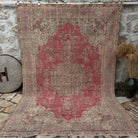 Red 7' x 11' Turkish traditional anatolian rug in wool and cotton, shown on the floor.