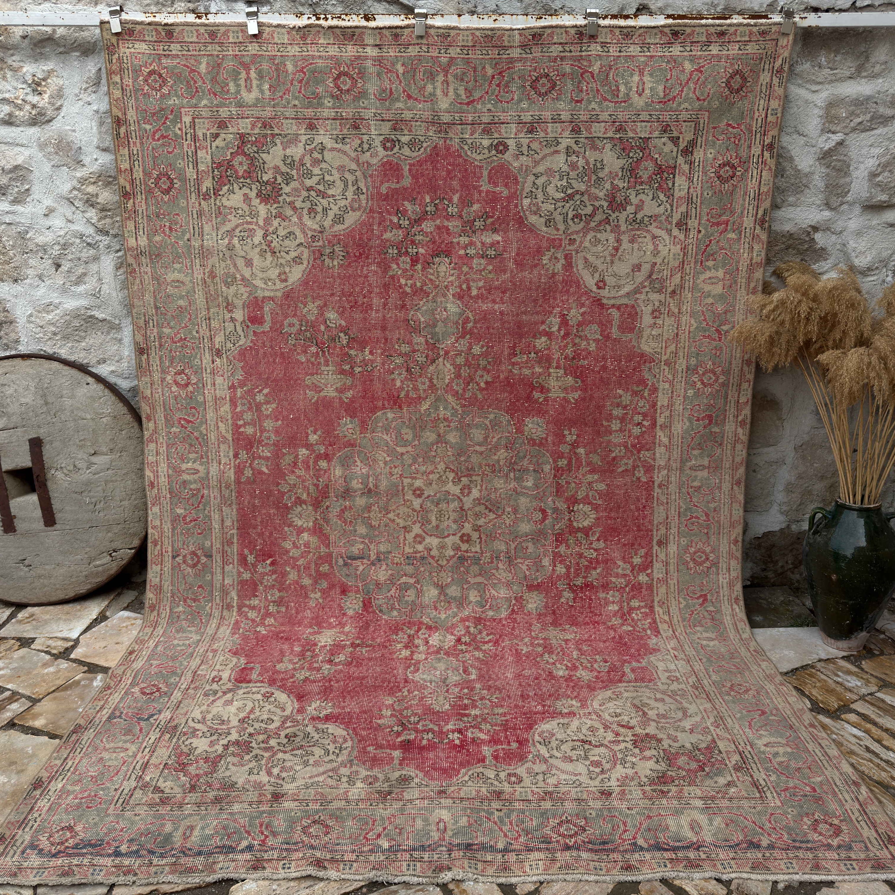 Red 7' x 11' Turkish traditional anatolian rug in wool and cotton, shown on the floor.
