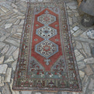 Red 4' x 8' Turkish traditional rug in wool and cotton, shown on the floor.