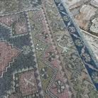 Close-up of the pink traditional turkish rug, hand-knotted weave, wool and cotton and low pile.