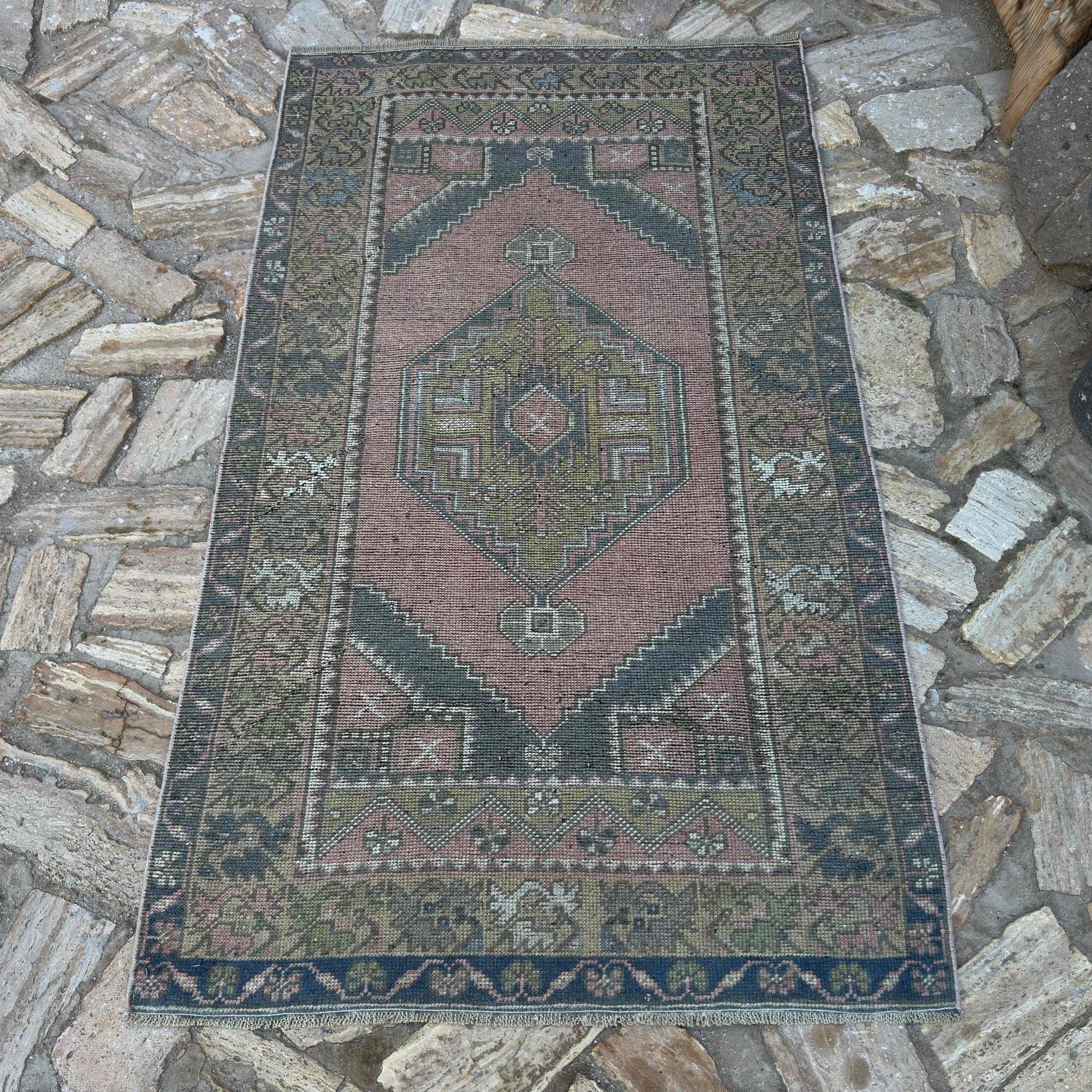 Pink 3' x 6' traditional turkish rug in wool and cotton, shown on the floor.