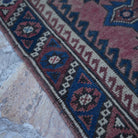 Red 2' x 4' Turkish traditional vintage rug in wool, shown on the floor.