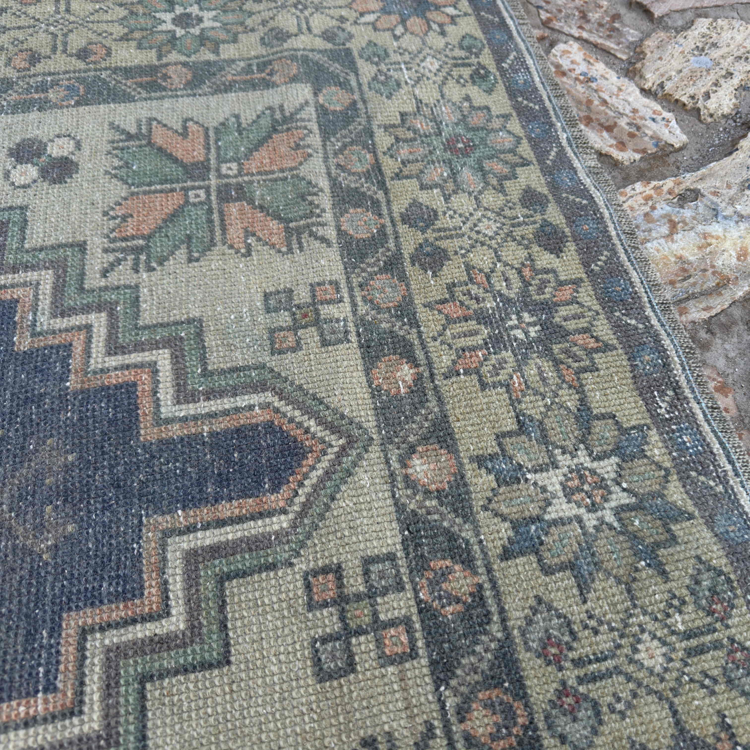 Close-up of the orange Turkish traditional vintage rug showing traditional details, hand-knotted weave, wool and cotton and low pile.
