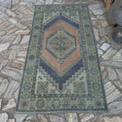 Orange 4' x 6' Turkish traditional vintage rug in wool and cotton, shown on the floor.