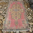 Pale Pink 4' x 7' Turkish traditional vintage rug in wool and cotton, shown on the floor.