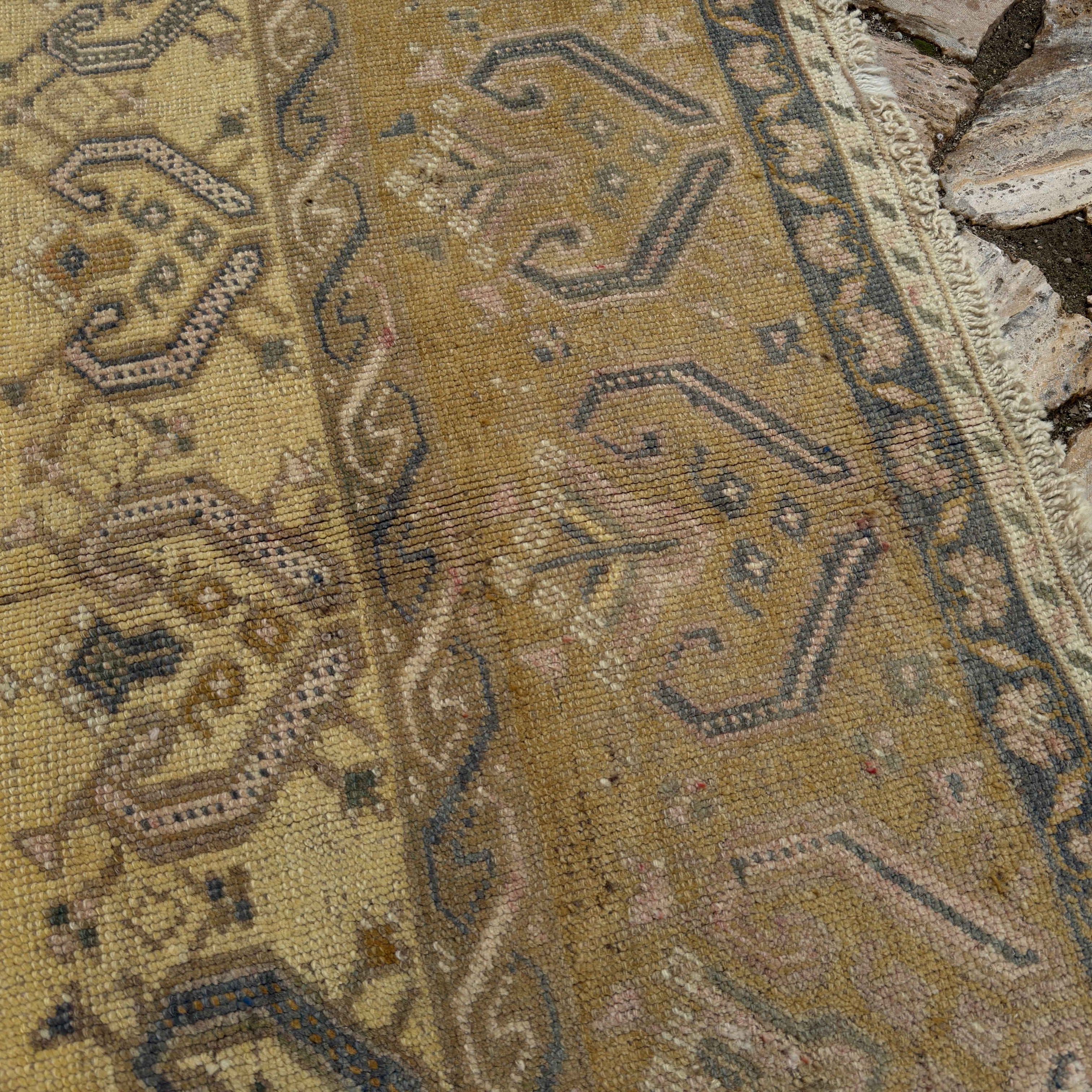 Close-up of the yellow Turkish traditional wool rug showing neutral details, hand-knotted weave, wool and cotton and low pile.