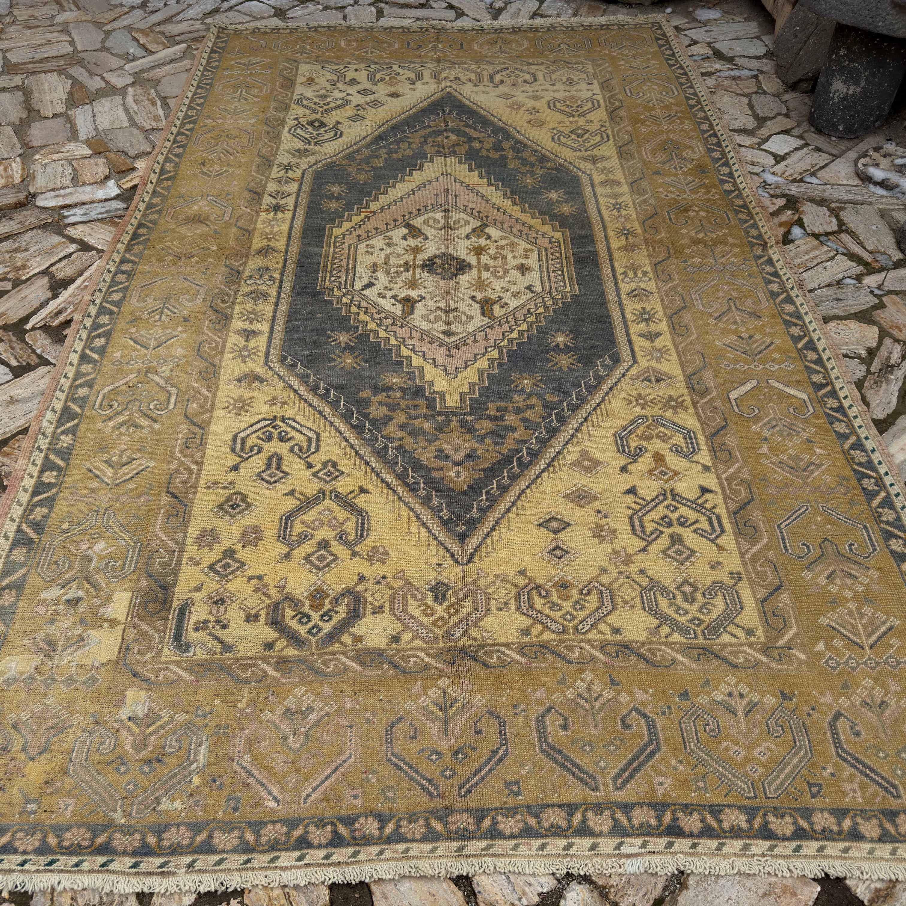 Yellow 7' x 11' Turkish traditional wool rug in wool and cotton, shown on the floor.