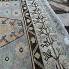 Close-up of the pale orange turkish area rug showing traditional details, hand-knotted weave, wool and cotton and low pile.