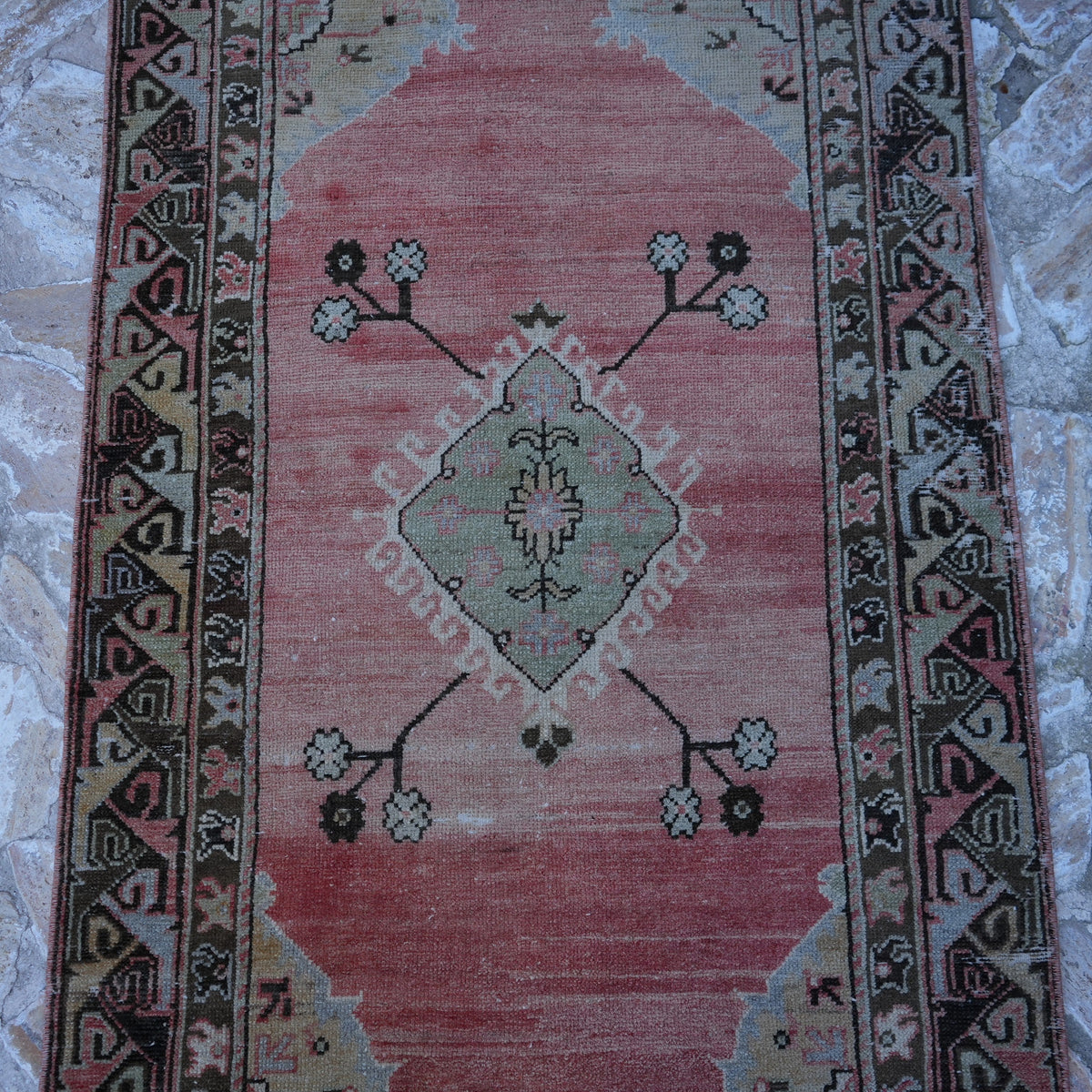 Close-up of the red turkish area rug, hand-knotted weave, wool and cotton and low pile.