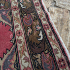 Close-up of the red turkish geometric runner rug showing traditional details, hand-knotted weave, wool and cotton and low pile.
