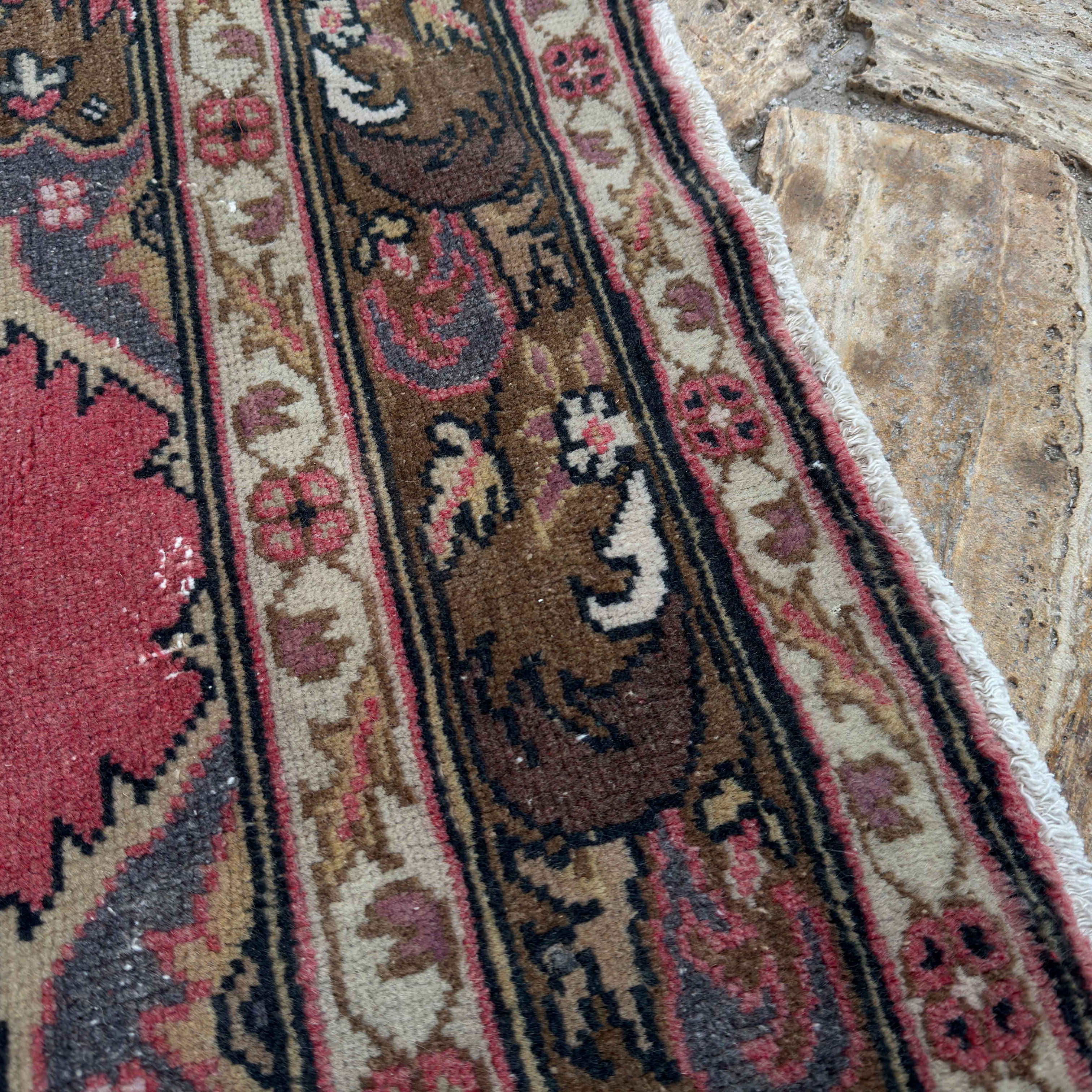 Close-up of the red turkish geometric runner rug showing traditional details, hand-knotted weave, wool and cotton and low pile.