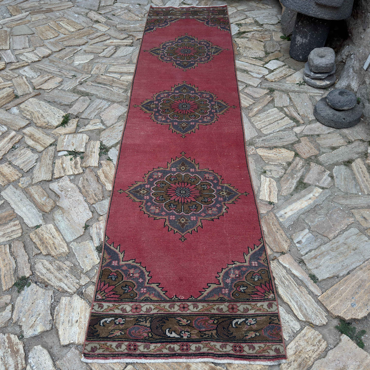 Red 3' x 11' turkish geometric runner rug in wool and cotton, shown on the floor.