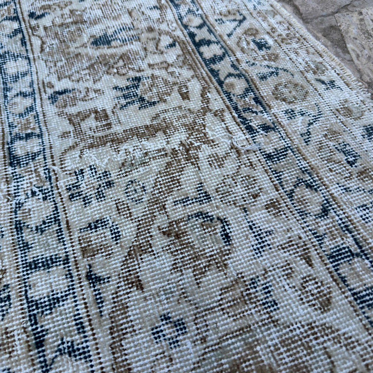 Close-up of the blue turkish large rug showing medallion and neutral details, hand-knotted weave, wool and cotton and low pile.