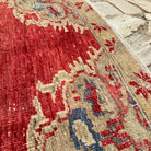 Close-up of the red turkish medallion rug showing medallion details, hand-knotted weave, wool and cotton and low pile.