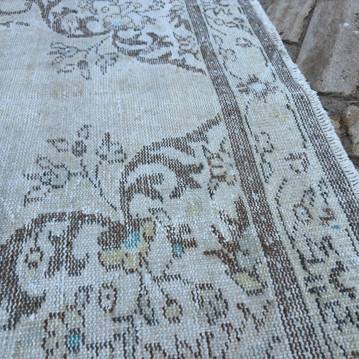 Close-up of the brown turkish medallion rug showing medallion details, hand-knotted weave, wool and cotton and low pile.