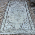 Brown 6' x 9' turkish medallion rug in wool and cotton, shown on the floor.