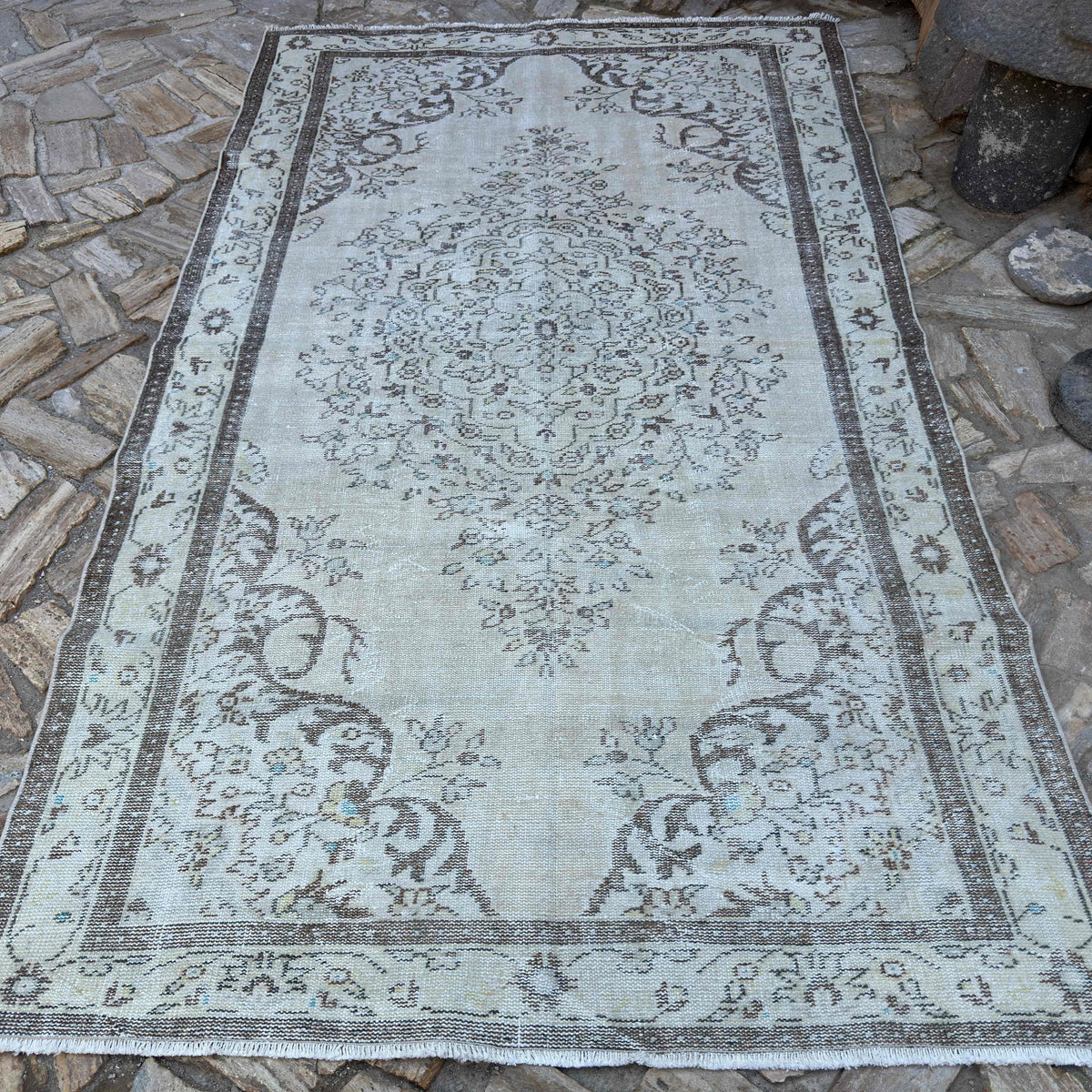 Brown 6' x 9' turkish medallion rug in wool and cotton, shown on the floor.