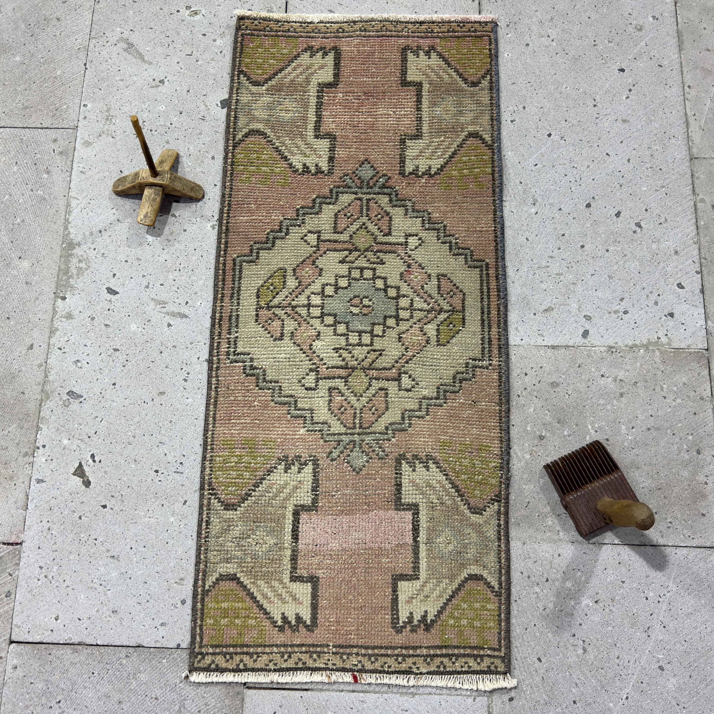 Pink 1' x 3' turkish mini rug in wool and cotton, shown on the floor.