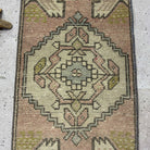1970s pink turkish mini rug with traditional design, hand-knotted weave and low pile.