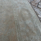 Close-up of the beige turkish oushak rug showing neutral details, hand-knotted weave, wool and cotton and low pile.