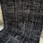 Gray 6' x 10' turkish overdyed rug in wool and cotton, shown on the floor.