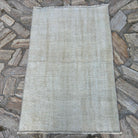 Beige 3' x 4' turkish rug in wool and cotton, shown on the floor.