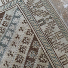 Close-up of the pale blue turkish rug showing striped details, hand-knotted weave, wool and cotton and low pile.