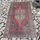 Pale Red 4' x 7' turkish rug in wool and cotton, shown on the floor.