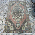 Pale Red 4' x 8' turkish rug in wool and cotton, shown on the floor.