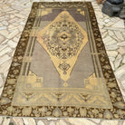 Gray 5' x 10' turkish rug in wool and cotton, shown on the floor.