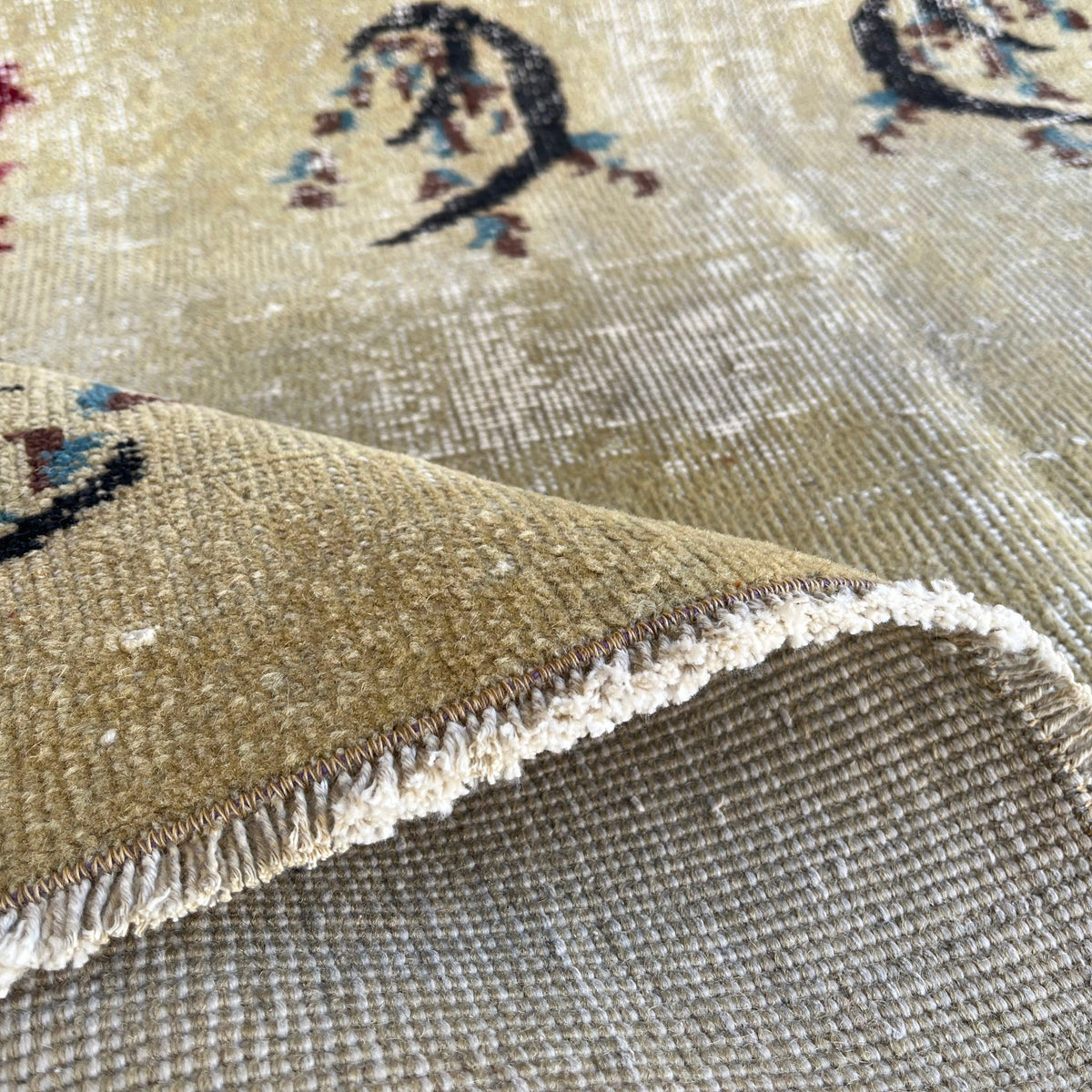 Close-up of the black turkish rug showing traditional details, hand-knotted weave, wool and cotton and low pile.