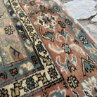 Close-up of the beige turkish rug showing geometric details, hand-knotted weave, wool and cotton and low pile.