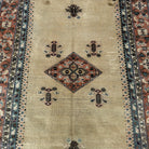 1970s beige turkish rug with geometric design, hand-knotted weave and low pile.