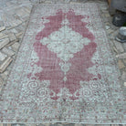 Red 6' x 9' turkish rug in wool and cotton, shown on the floor.