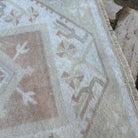 Close-up of the beige turkish runner rug showing neutral details, hand-knotted weave, wool and cotton and low pile.