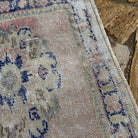 Close-up of the pale pink turkish runner rug showing medallion details, hand-knotted weave, wool and cotton and low pile.