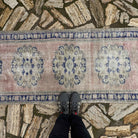 1970s pale pink turkish runner rug with medallion design, hand-knotted weave and low pile.