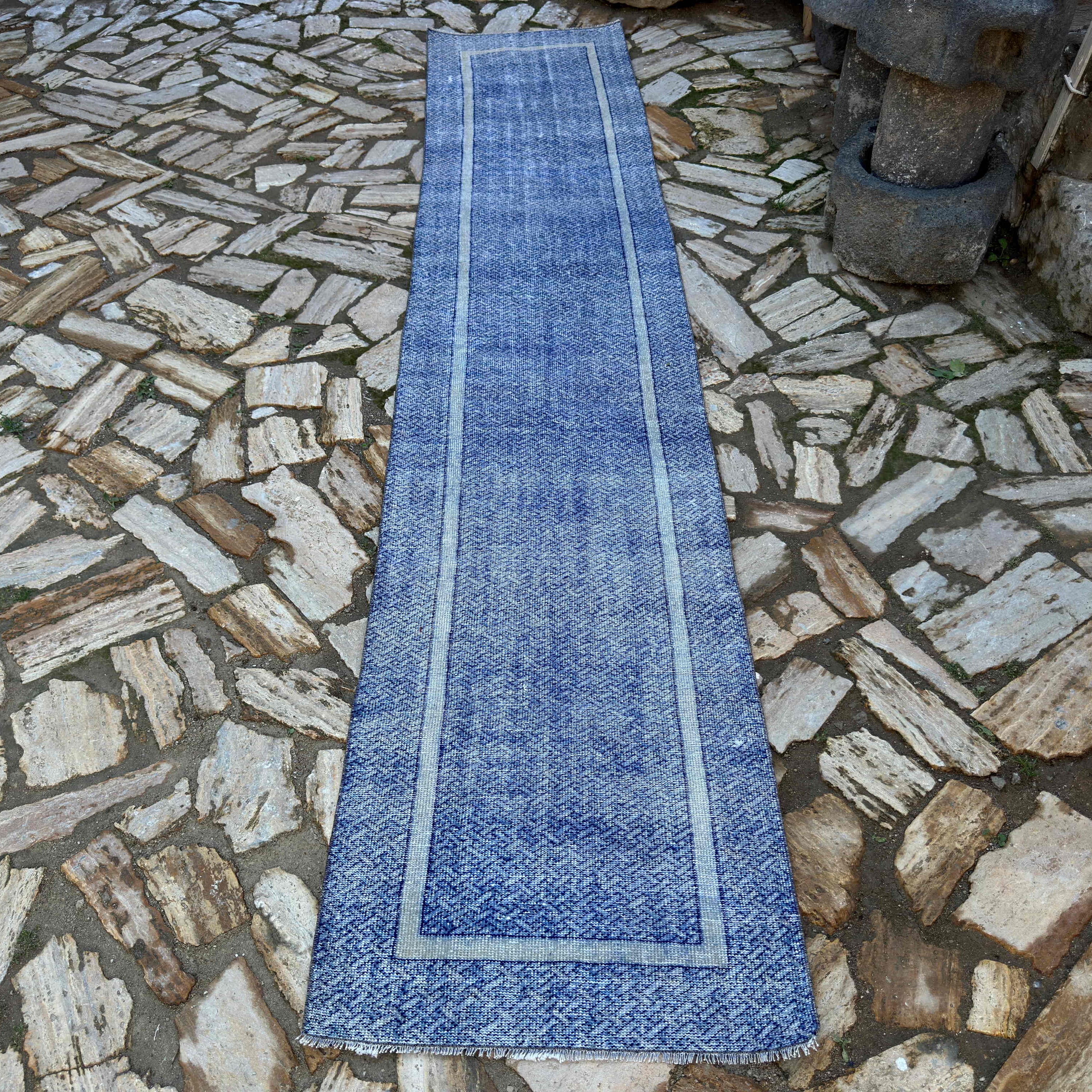 Blue 2' x 12' turkish runner rug in wool and cotton, shown on the floor.