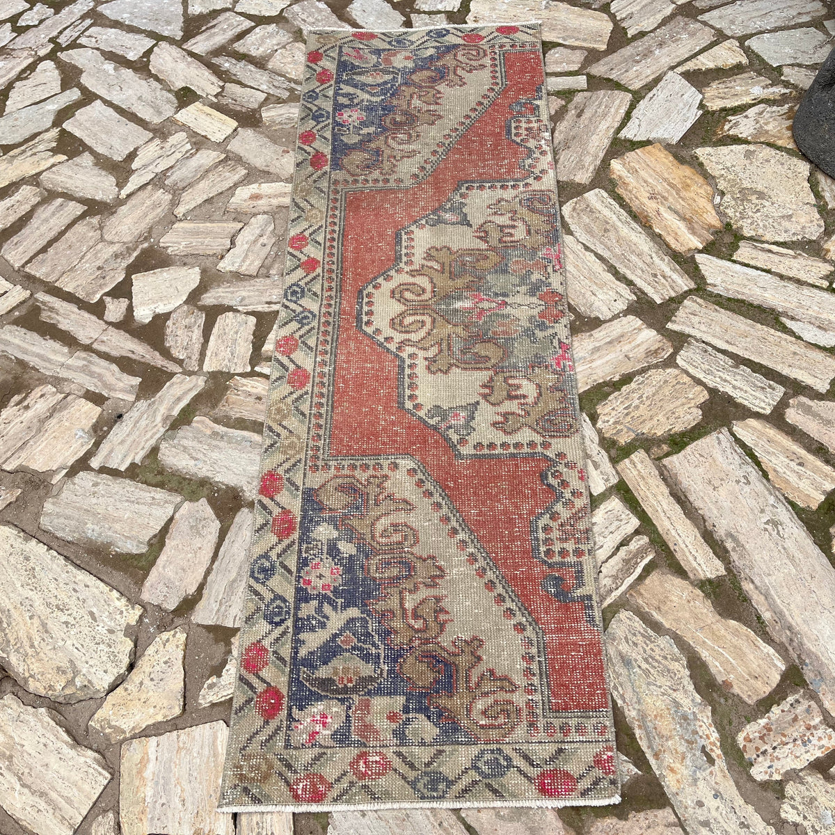 Red 2' x 7' turkish runner rug in wool and cotton, shown on the floor.