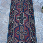 Close-up of the red turkish runner rug showing traditional details, hand-knotted weave, wool and low pile.