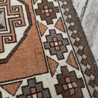 Close-up of the pale orange turkish runner rug showing traditional details, hand-knotted weave, wool and cotton and low pile.