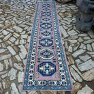 Pink 3' x 12' turkish runner rug in wool and cotton, shown on the floor.